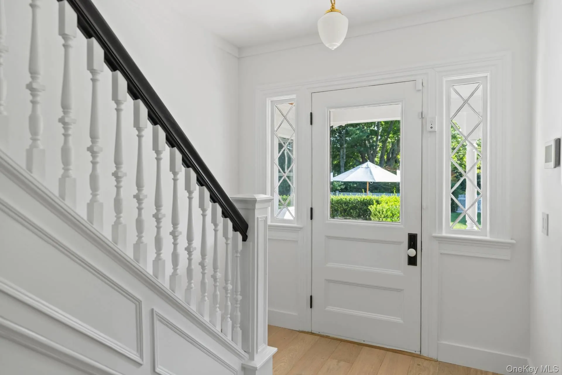 Foyer with light wood-style floors and stairway Foyer with light wood-style floors and stairway