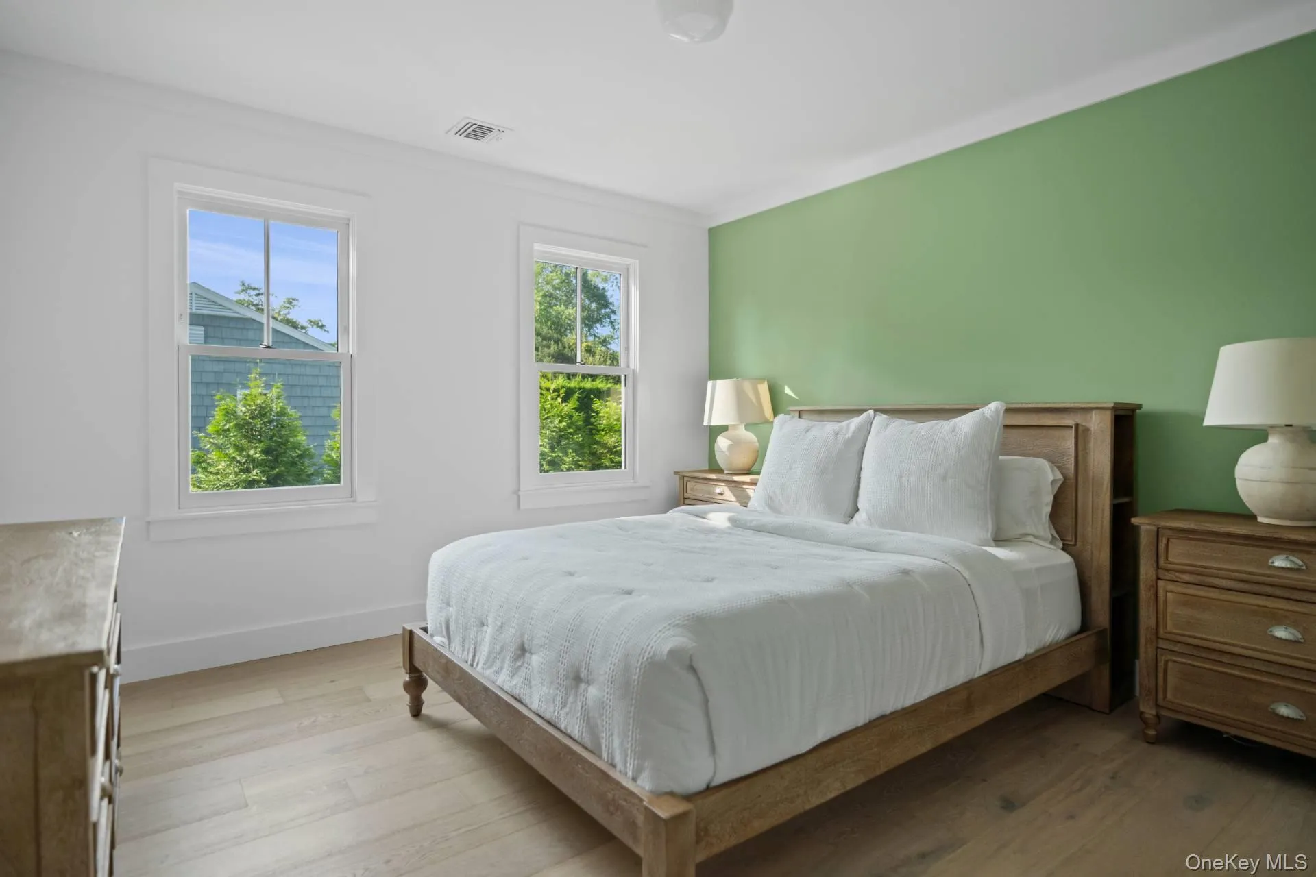 Bedroom with wood finished floors and baseboards Bedroom with wood finished floors and baseboards