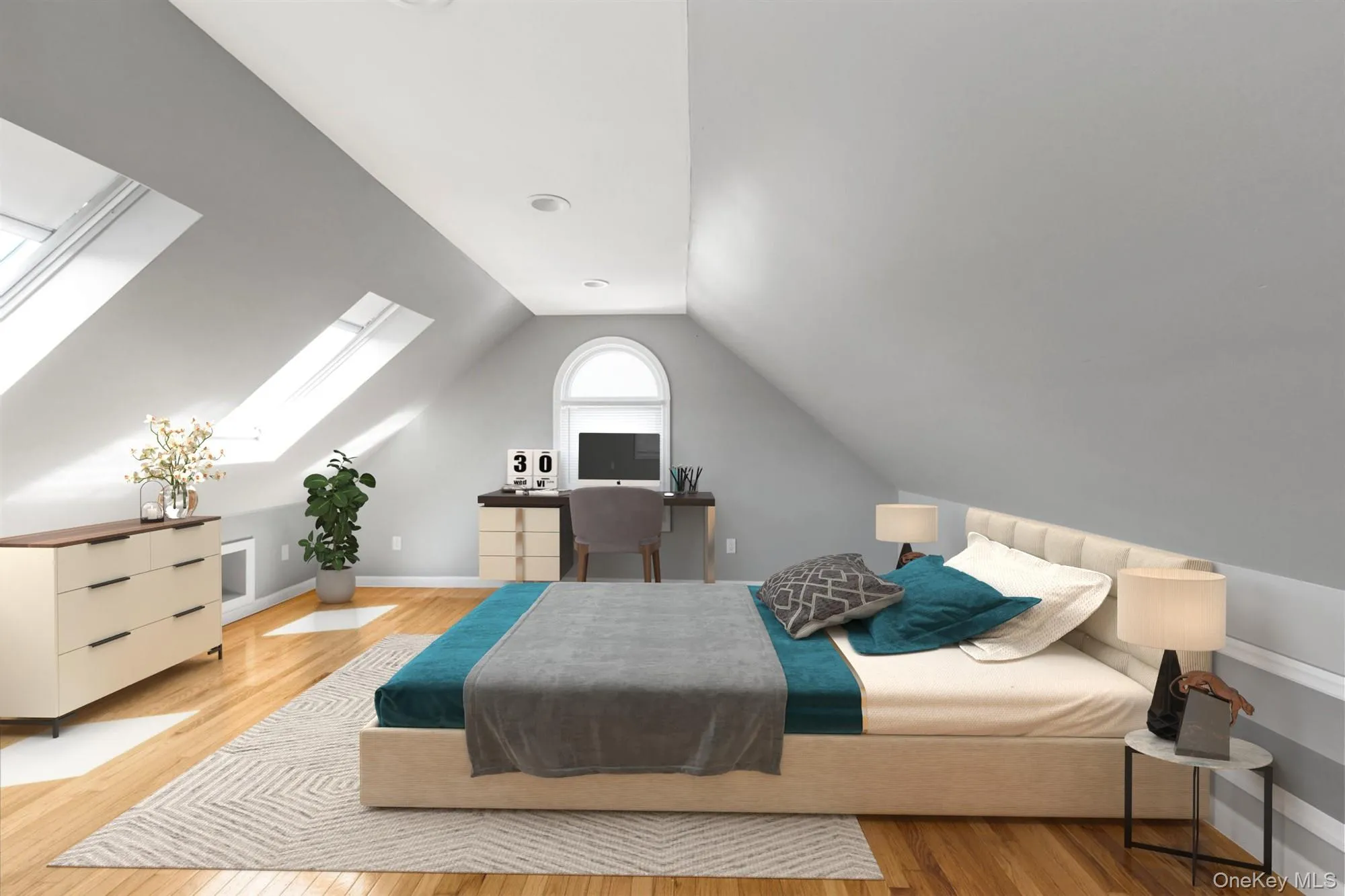 Bedroom with lofted ceiling, light wood-style floors, a skylight, and an office area Bedroom with lofted ceiling, light wood-style floors, a skylight, and an office area