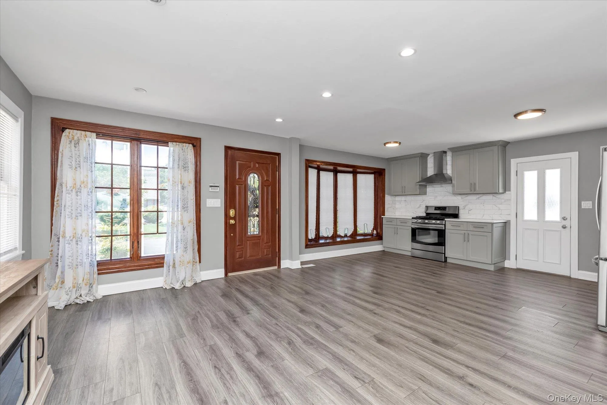 Unfurnished living room with recessed lighting and dark wood-type flooring Unfurnished living room with recessed lighting and dark wood-type flooring