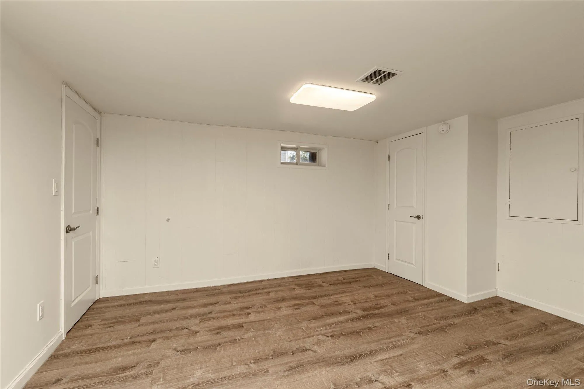 Below grade area featuring wood finished floors and baseboards Below grade area featuring wood finished floors and baseboards