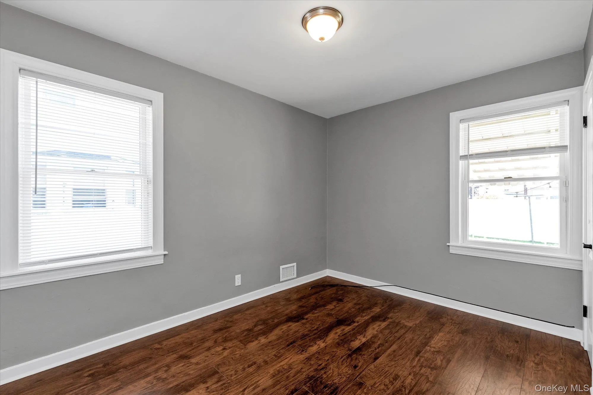 Empty room featuring dark wood-style floors Empty room featuring dark wood-style floors
