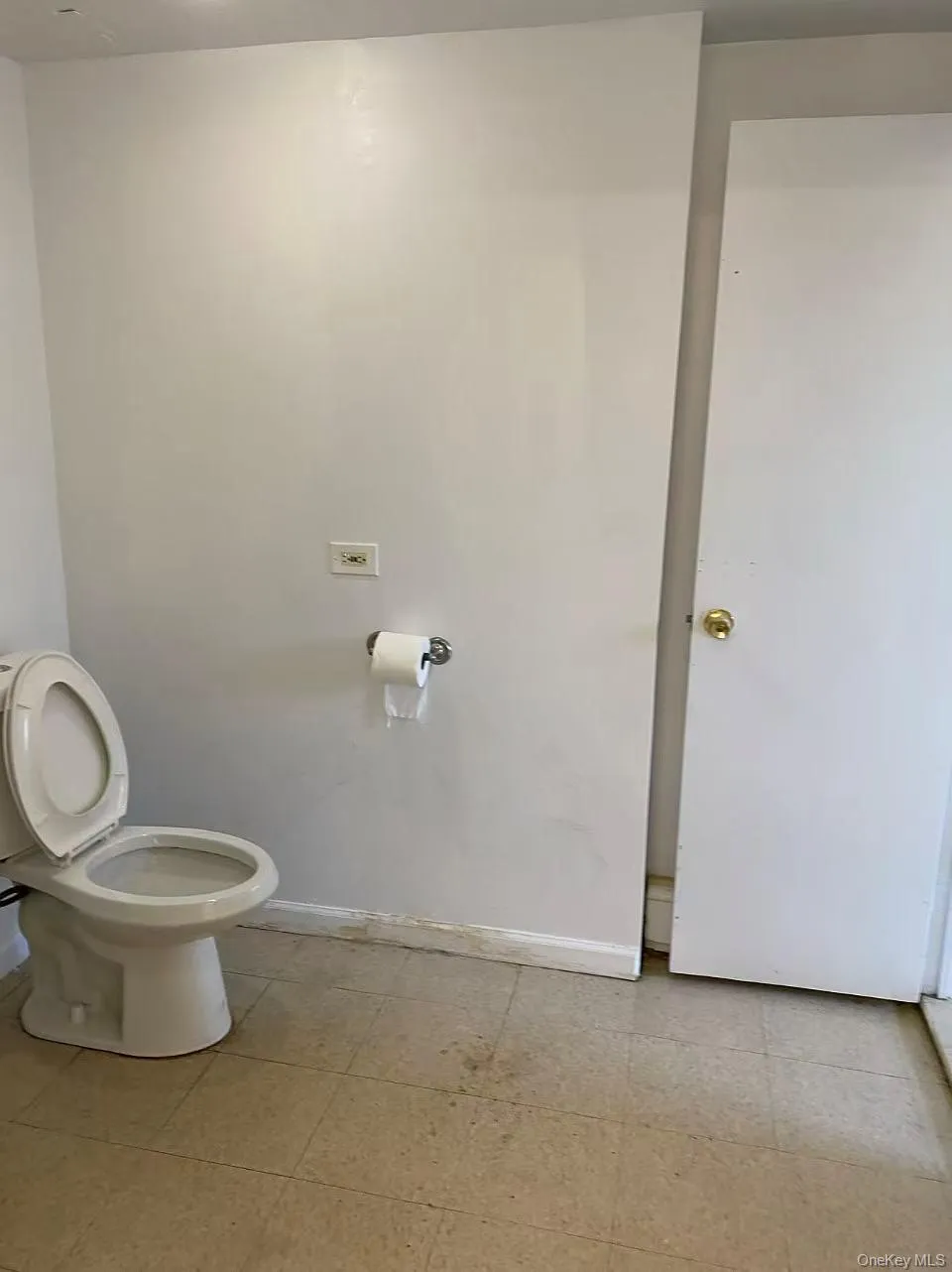 Bathroom featuring toilet and baseboards Bathroom featuring toilet and baseboards