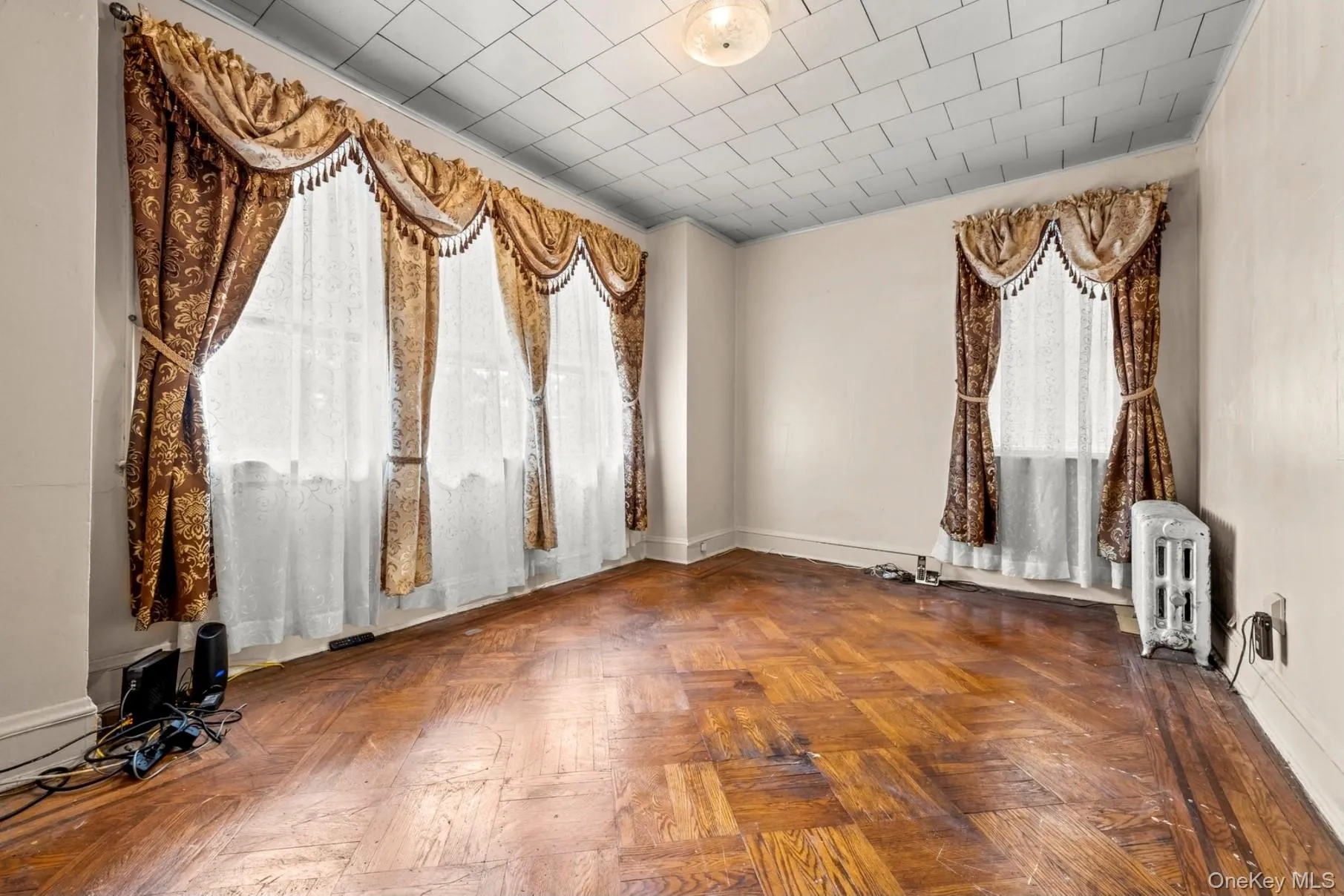 Spare room featuring radiator and baseboards Spare room featuring radiator and baseboards