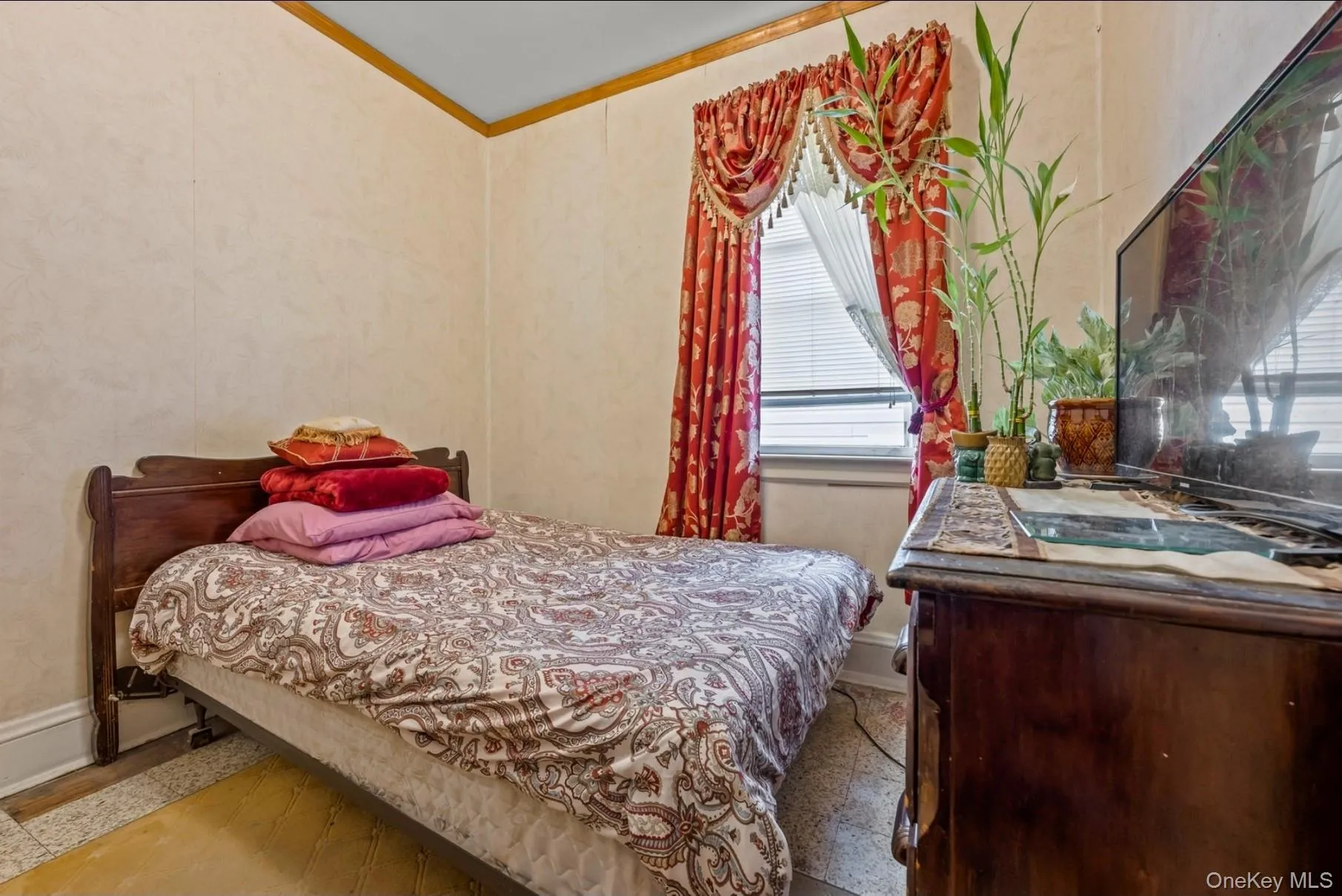 Bedroom featuring ornamental molding and baseboards Bedroom featuring ornamental molding and baseboards
