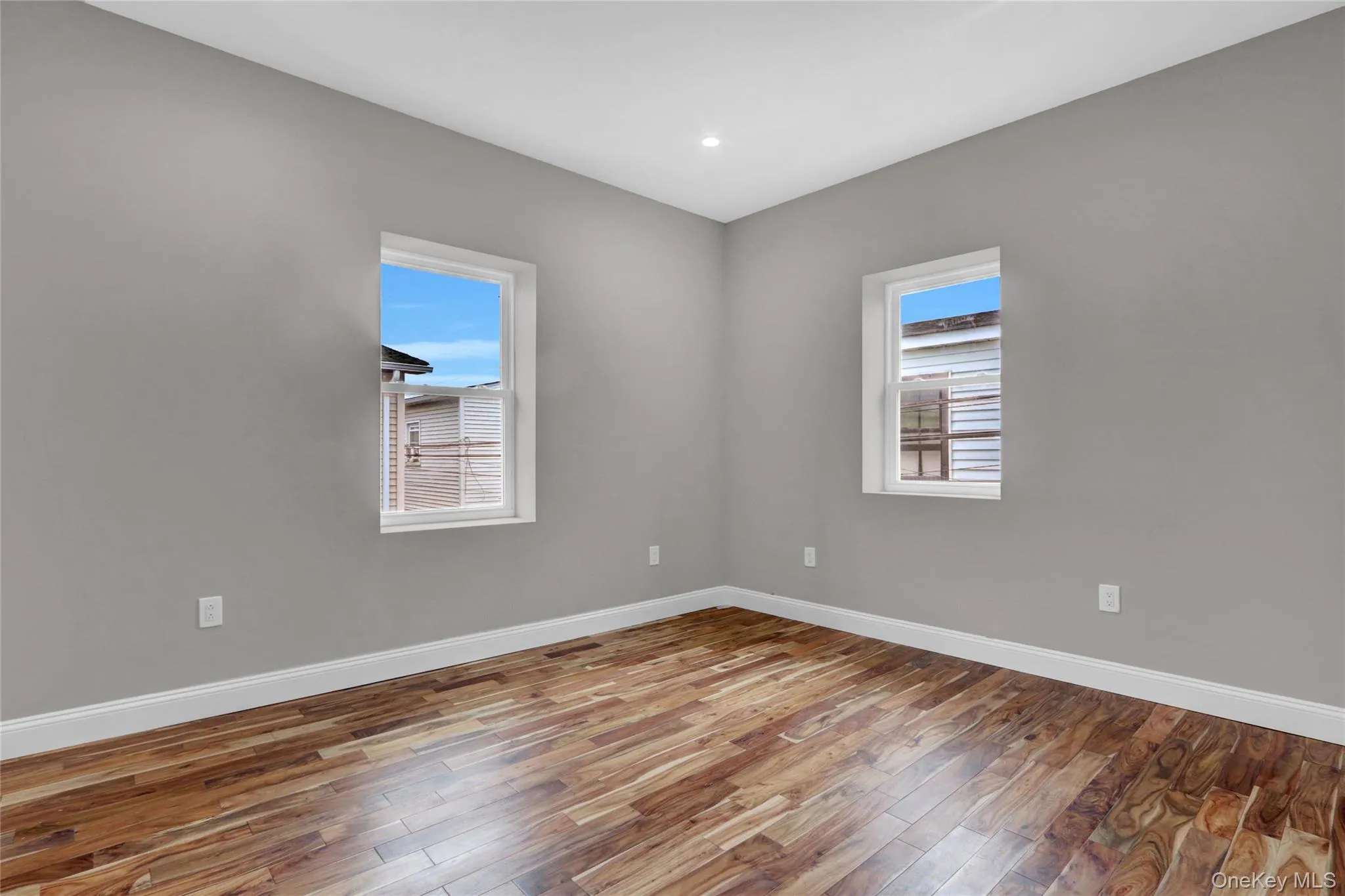 Spare room featuring wood finished floors and recessed lighting Spare room featuring wood finished floors and recessed lighting