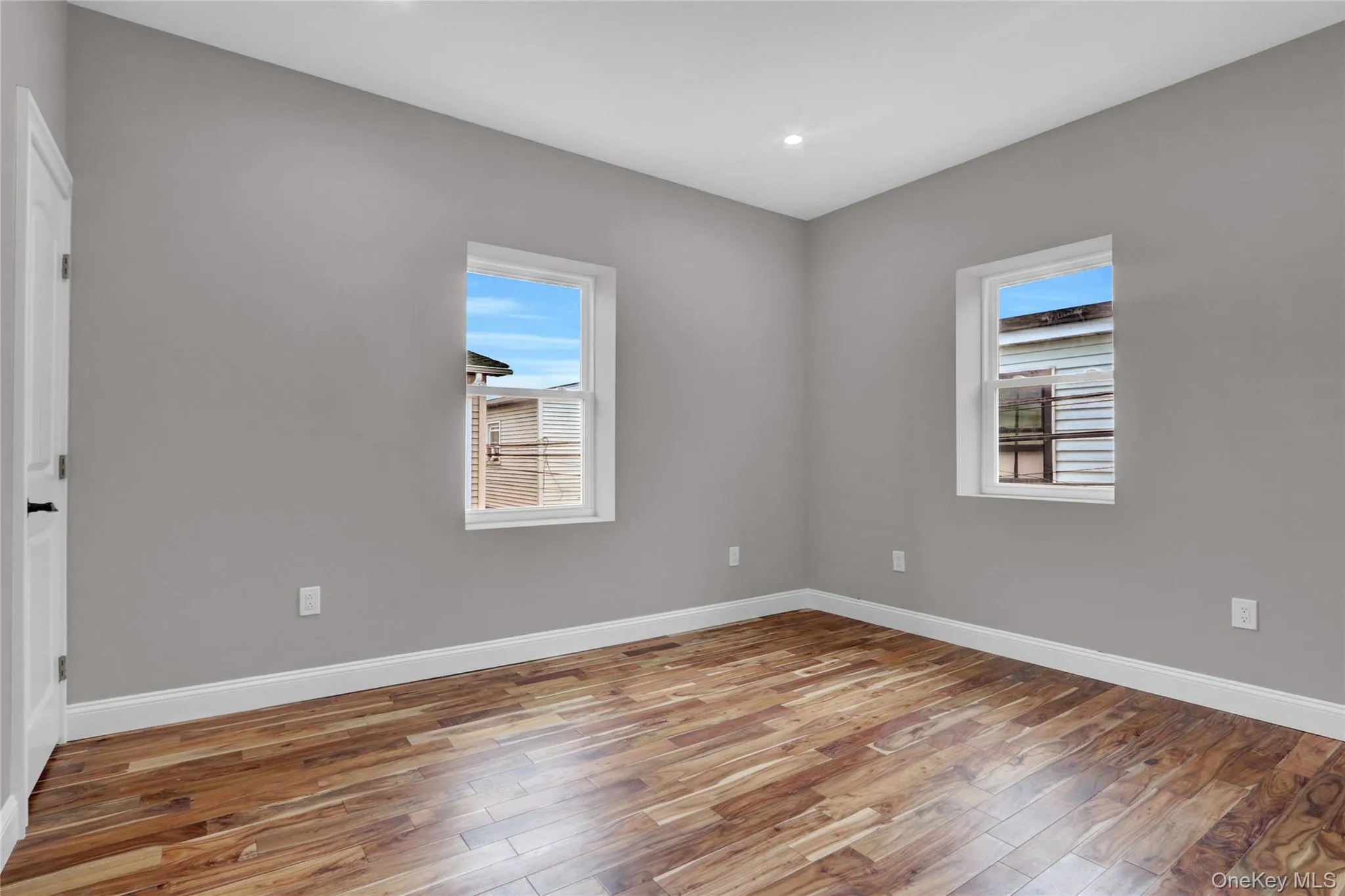 Unfurnished room with light wood-type flooring, healthy amount of natural light, and recessed lighting Unfurnished room with light wood-type flooring, healthy amount of natural light, and recessed lighting