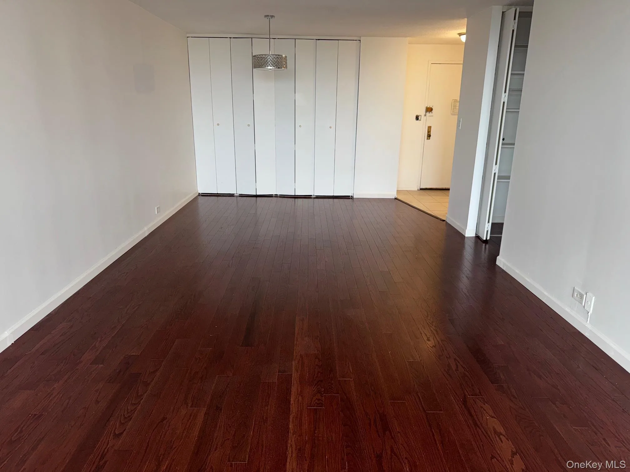 Spare room with dark wood-style flooring Spare room with dark wood-style flooring