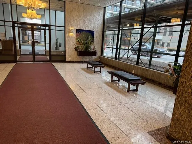 Community lobby with a wall of windows and a high ceiling Community lobby with a wall of windows and a high ceiling