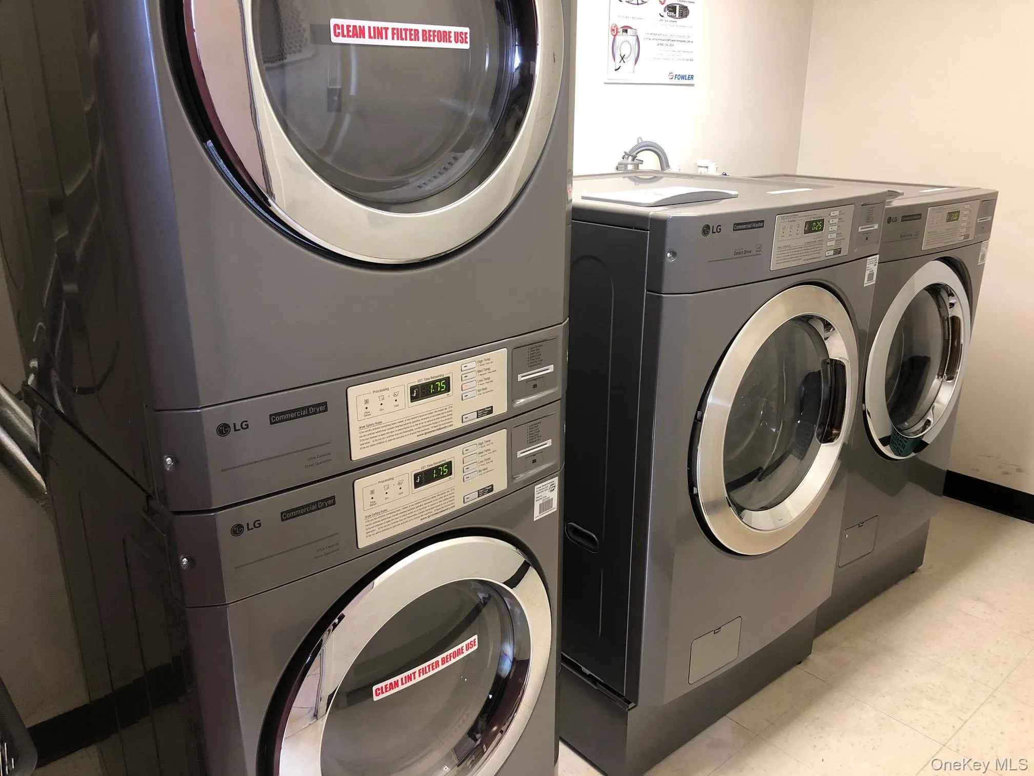 Washroom with estacked washer and dryer and baseboards Washroom with estacked washer and dryer and baseboards