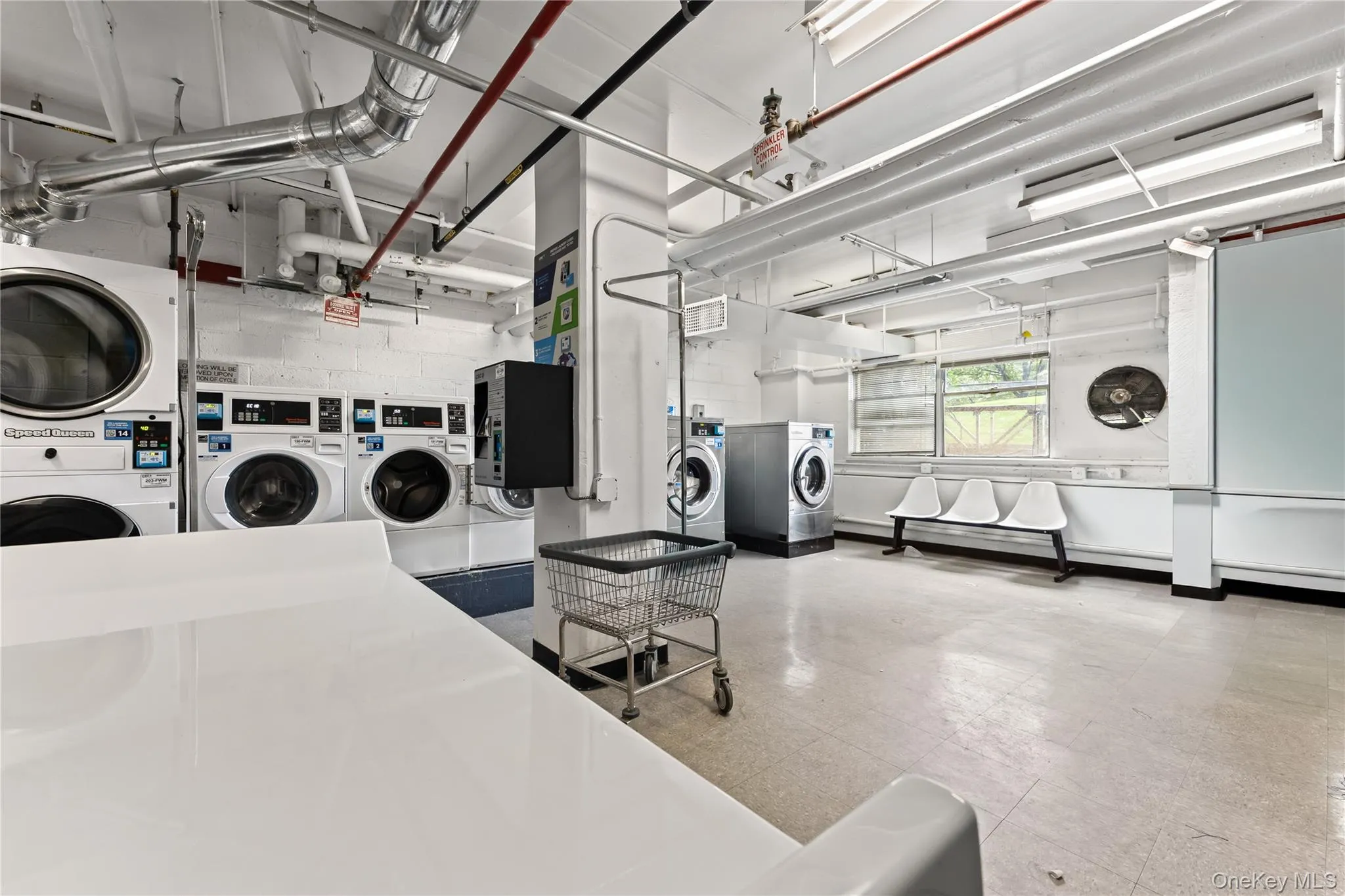 Community laundry room featuring separate washer and dryer Community laundry room featuring separate washer and dryer
