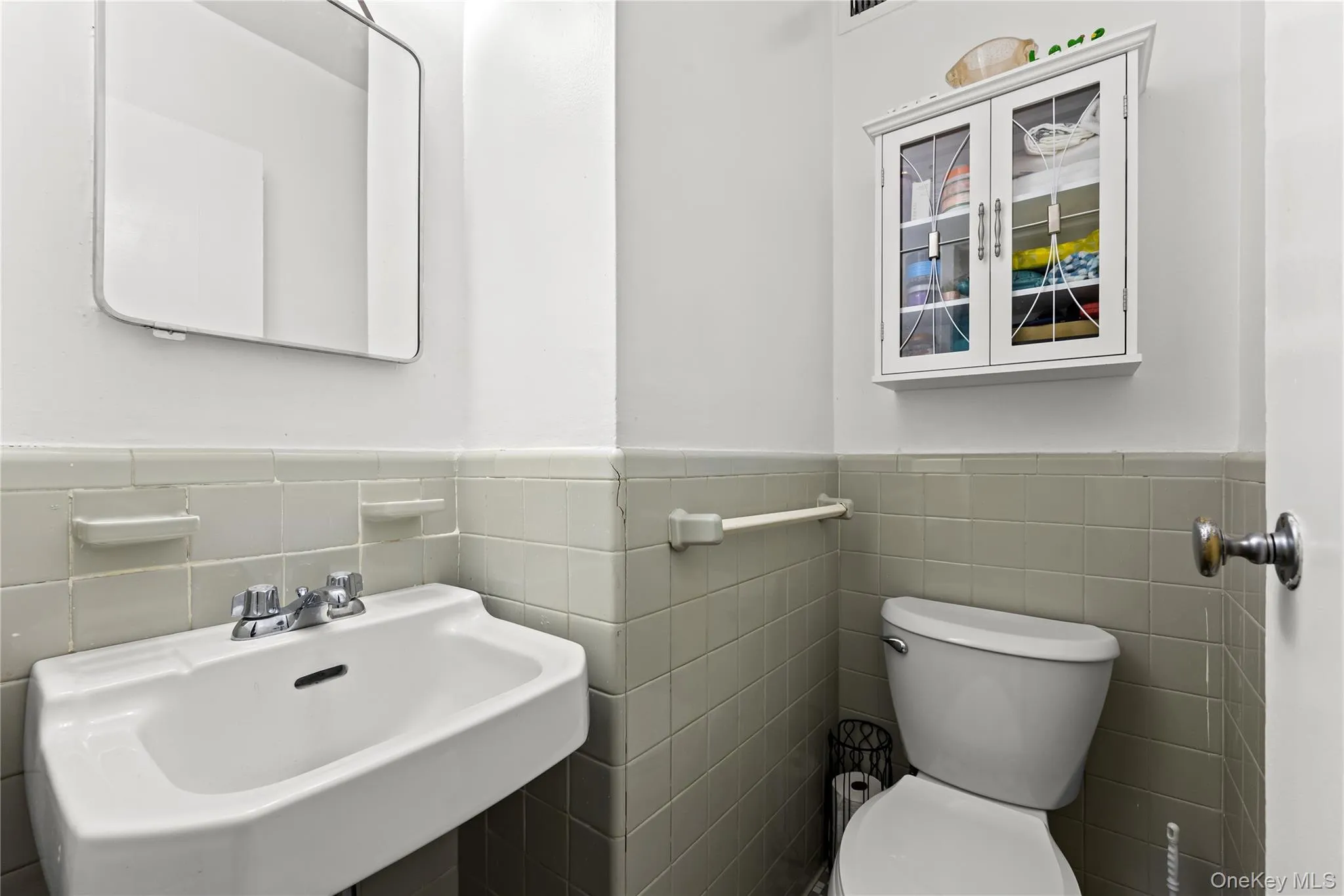 Bathroom with tile walls and wainscoting Bathroom with tile walls and wainscoting