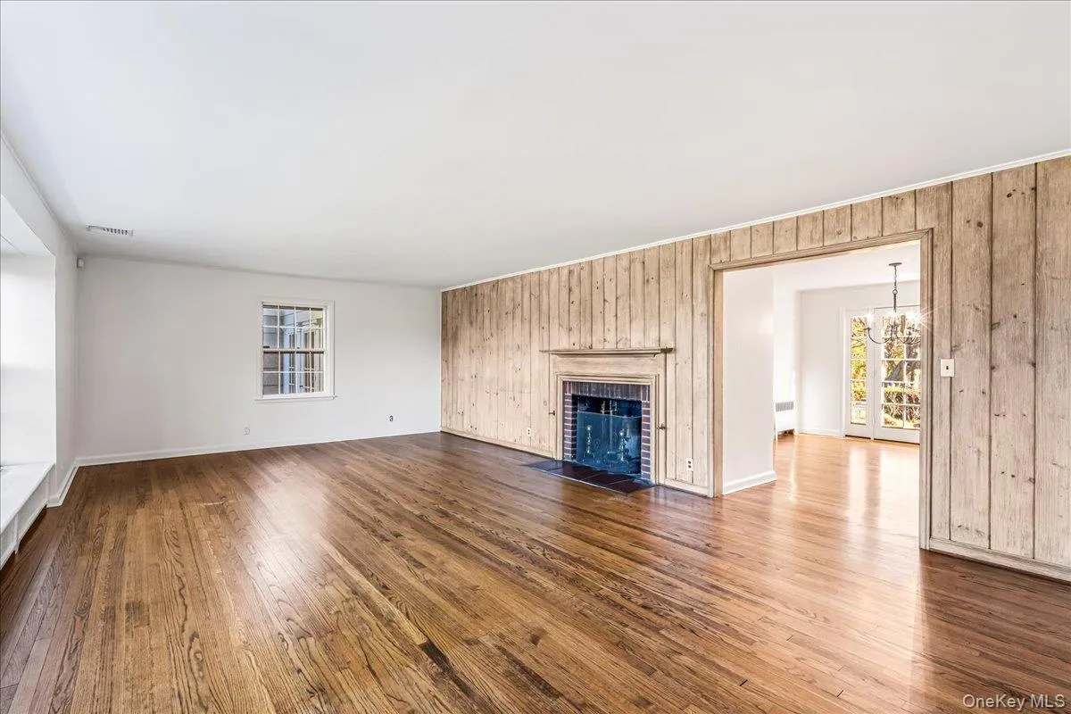 Unfurnished living room with wood floors, woodburning FP and entry to Dining Room Unfurnished living room with wood floors, woodburning FP and entry to Dining Room