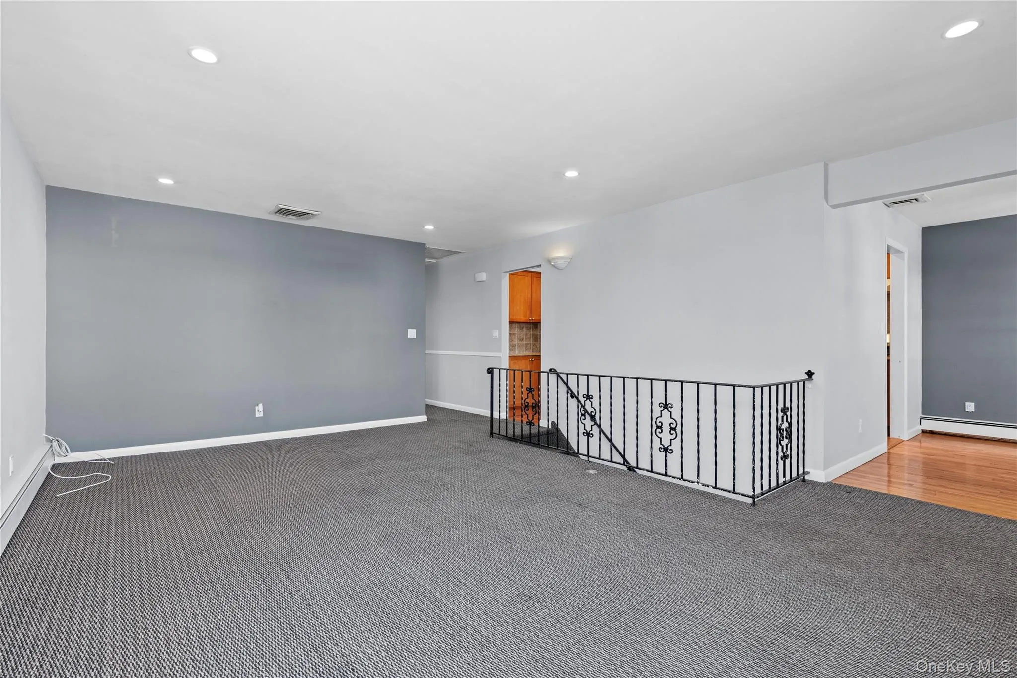 Unfurnished room with recessed lighting, carpet flooring, and baseboard heating Unfurnished room with recessed lighting, carpet flooring, and baseboard heating