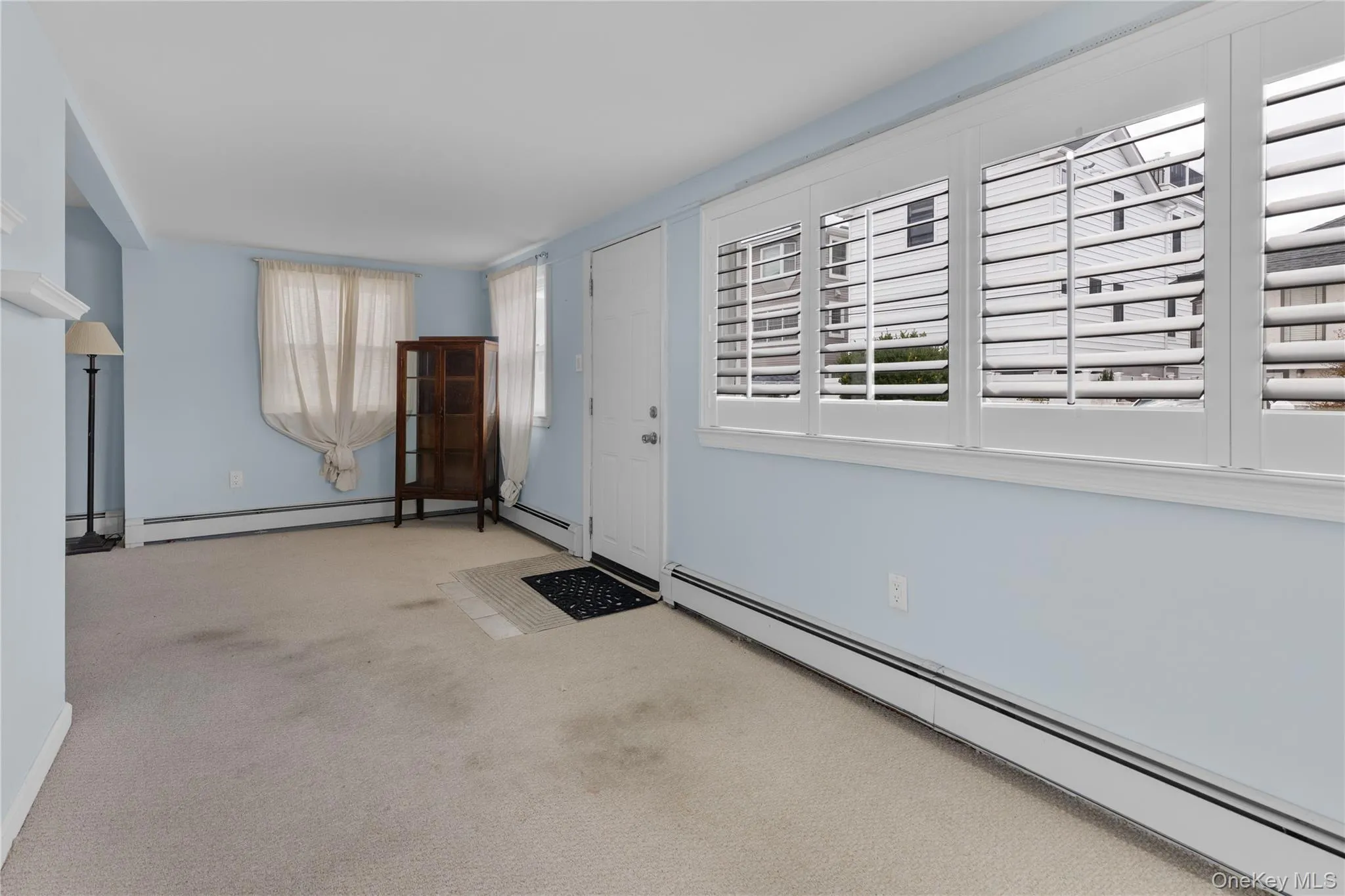 Carpeted foyer with baseboard heating Carpeted foyer with baseboard heating