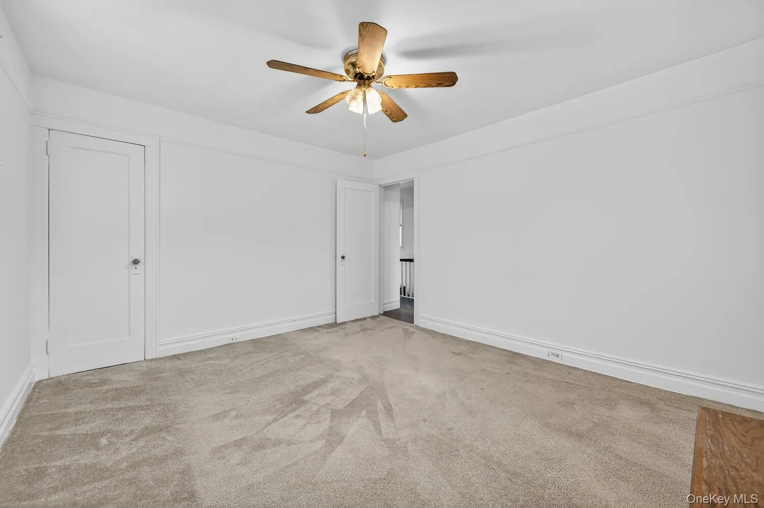 Bedroom with carpet floors and a ceiling fan Bedroom with carpet floors and a ceiling fan
