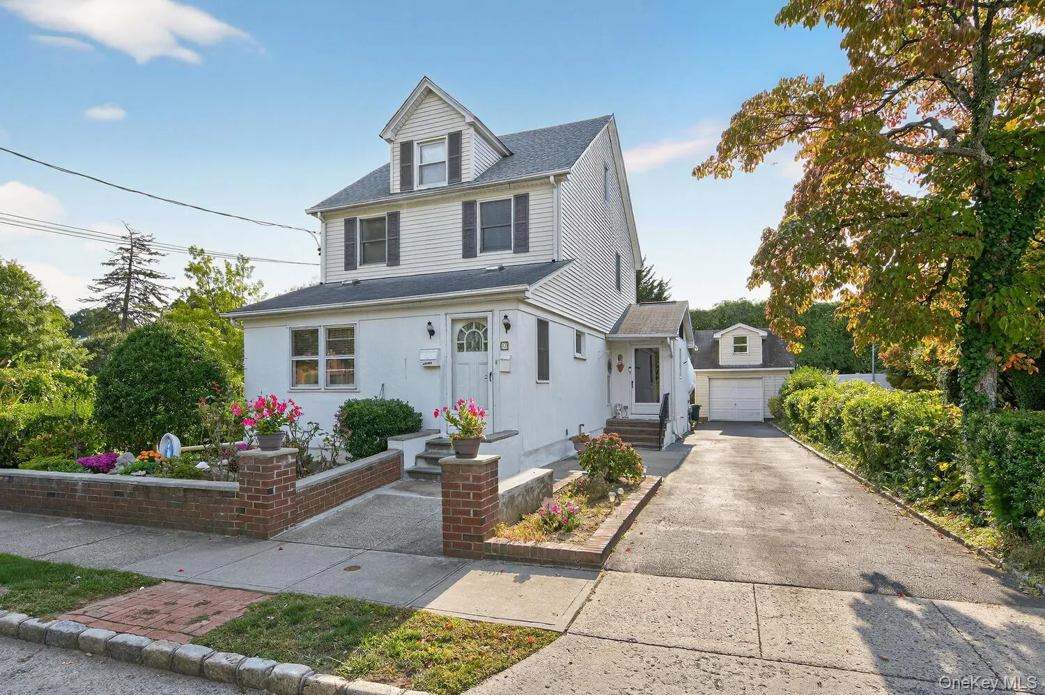 View of front of property with driveway and a shingled roof View of front of property with driveway and a shingled roof