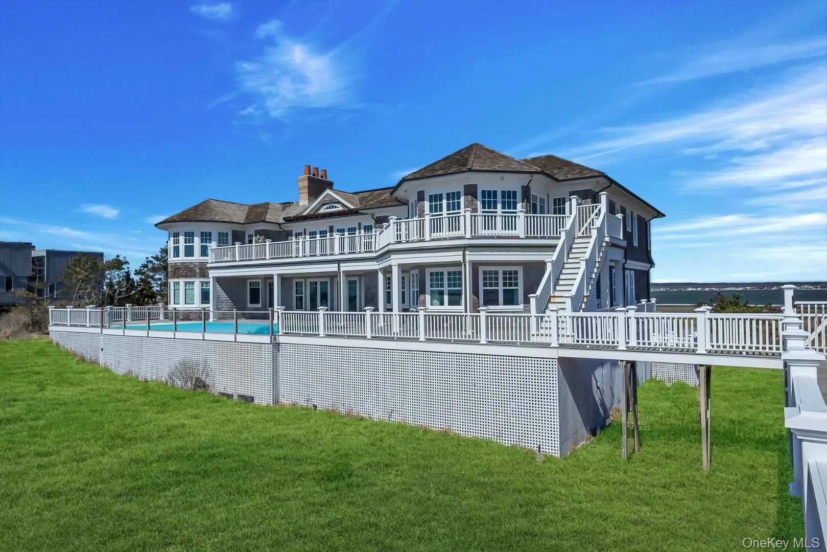 Back of property with expansive deck and pool Back of property with expansive deck and pool