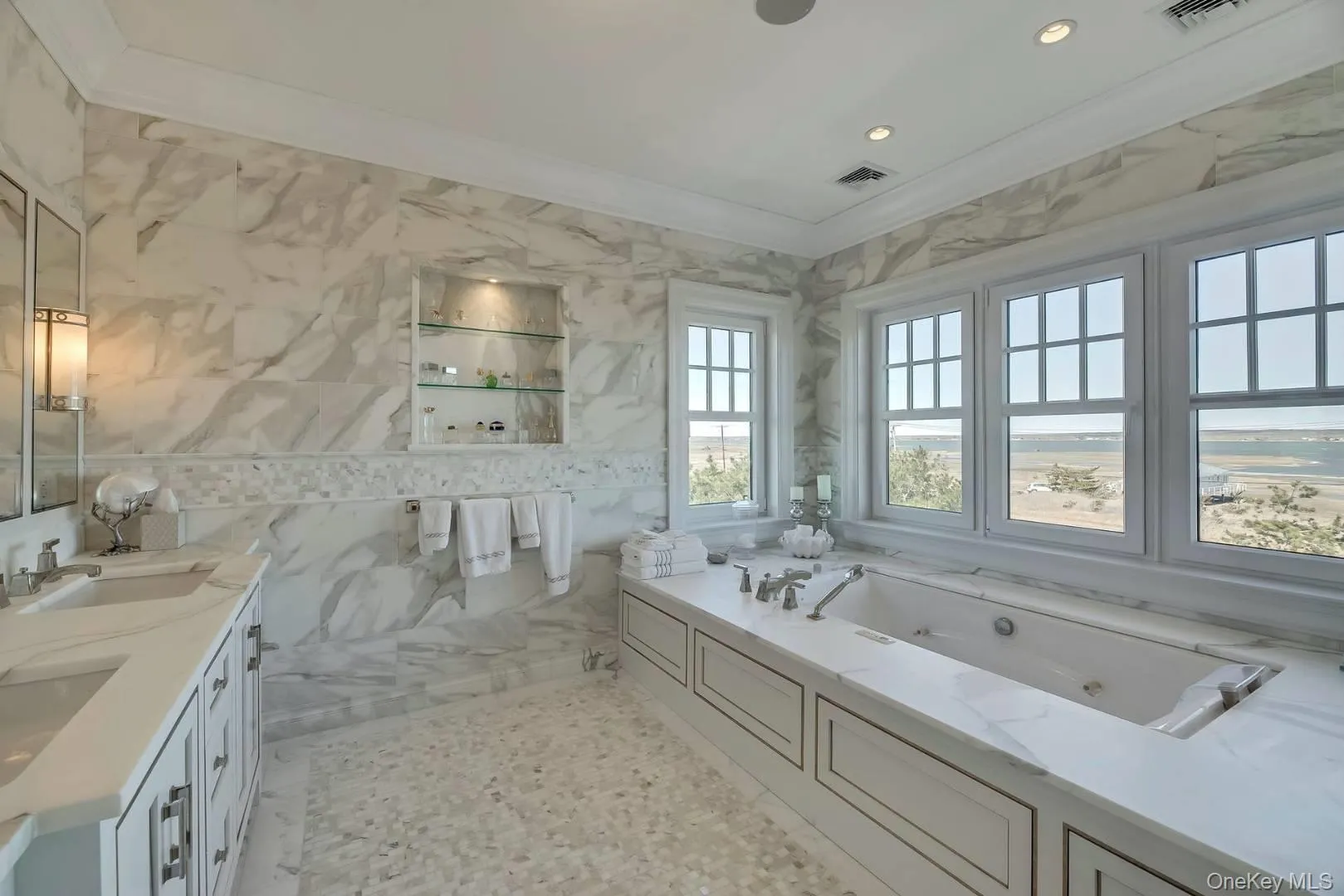 Bathroom with tile walls, ornamental molding, a whirlpool tub, double vanity, and recessed lighting Bathroom with tile walls, ornamental molding, a whirlpool tub, double vanity, and recessed lighting