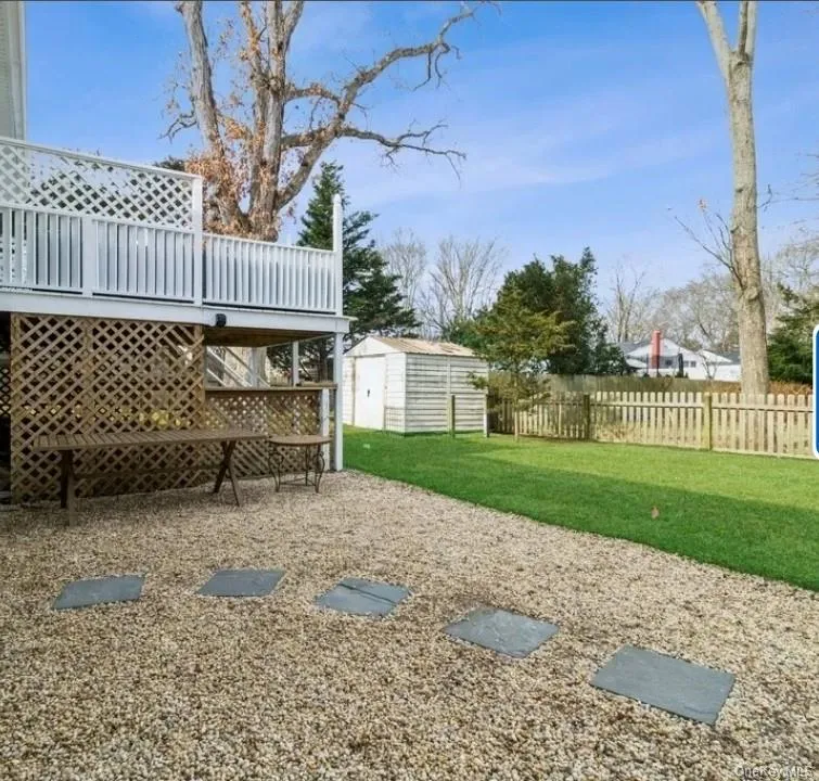 View of yard featuring a wooden deck and a storage unit View of yard featuring a wooden deck and a storage unit