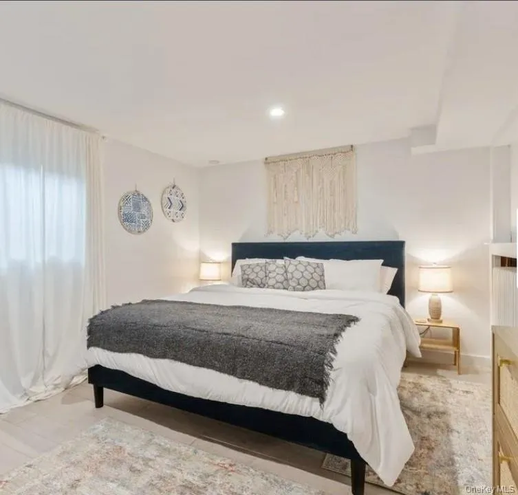 Bedroom featuring recessed lighting and light wood finished floors Bedroom featuring recessed lighting and light wood finished floors