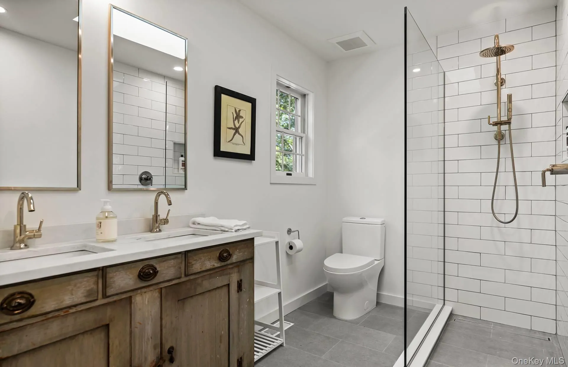 Full bathroom featuring double vanity, walk in shower, and dark tile patterned floors Full bathroom featuring double vanity, walk in shower, and dark tile patterned floors