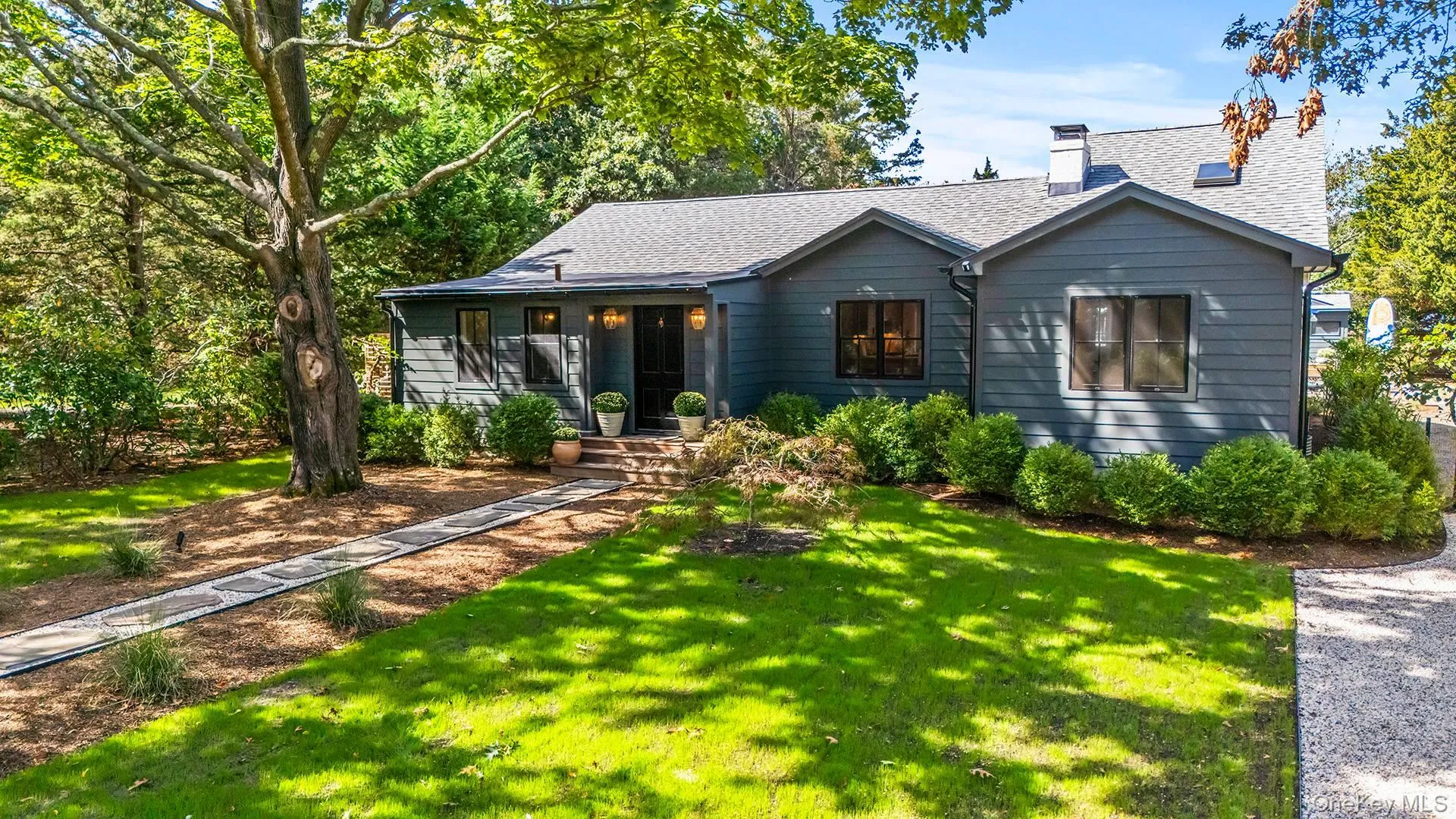 View of front of home with a chimney, a front yard, and roof with shingles View of front of home with a chimney, a front yard, and roof with shingles