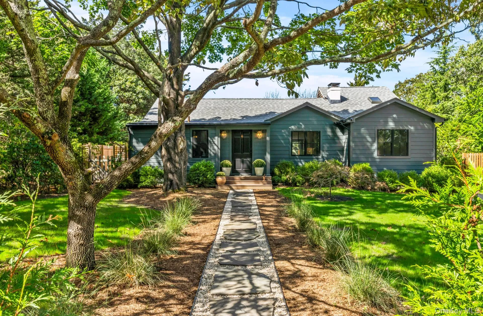 View of front of house featuring a shingled roof and a chimney View of front of house featuring a shingled roof and a chimney