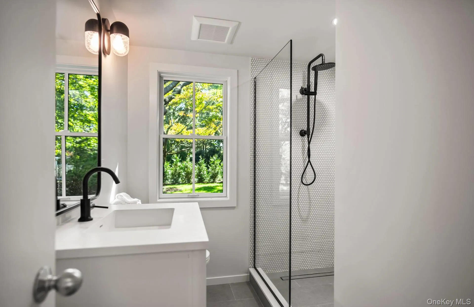 Full bath with vanity, a stall shower, and tile patterned floors Full bath with vanity, a stall shower, and tile patterned floors