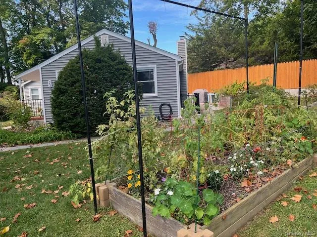 View of side of property featuring a vegetable garden and a chimney View of side of property featuring a vegetable garden and a chimney