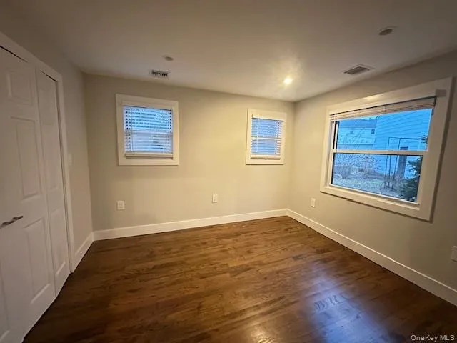 Unfurnished bedroom featuring dark wood-style floors, a closet, and recessed lighting Unfurnished bedroom featuring dark wood-style floors, a closet, and recessed lighting