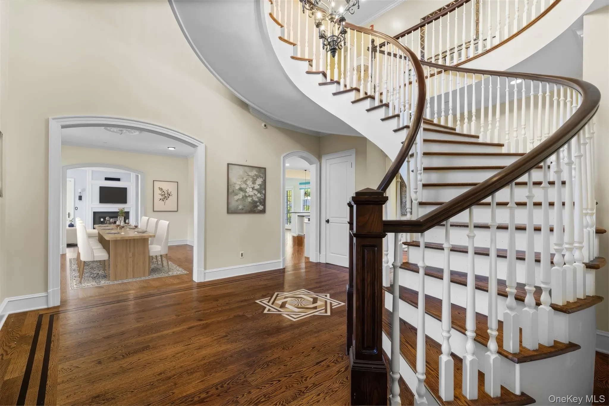 Gleaming hardwood floors with intricate wood inlay medallion with a view of the dining room. Virtually staged Gleaming hardwood floors with intricate wood inlay medallion with a view of the dining room. Virtually staged