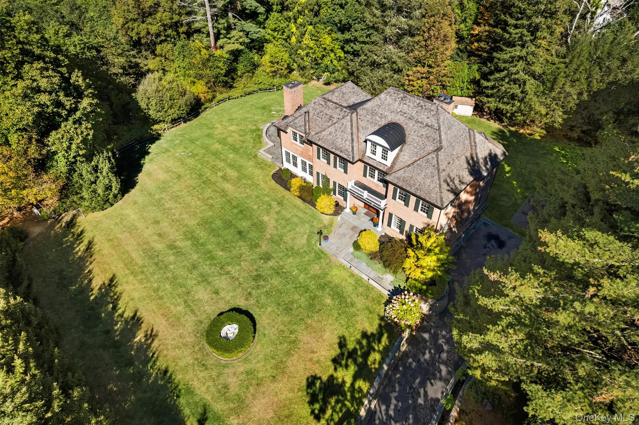 View from above of property featuring a heavily wooded area View from above of property featuring a heavily wooded area