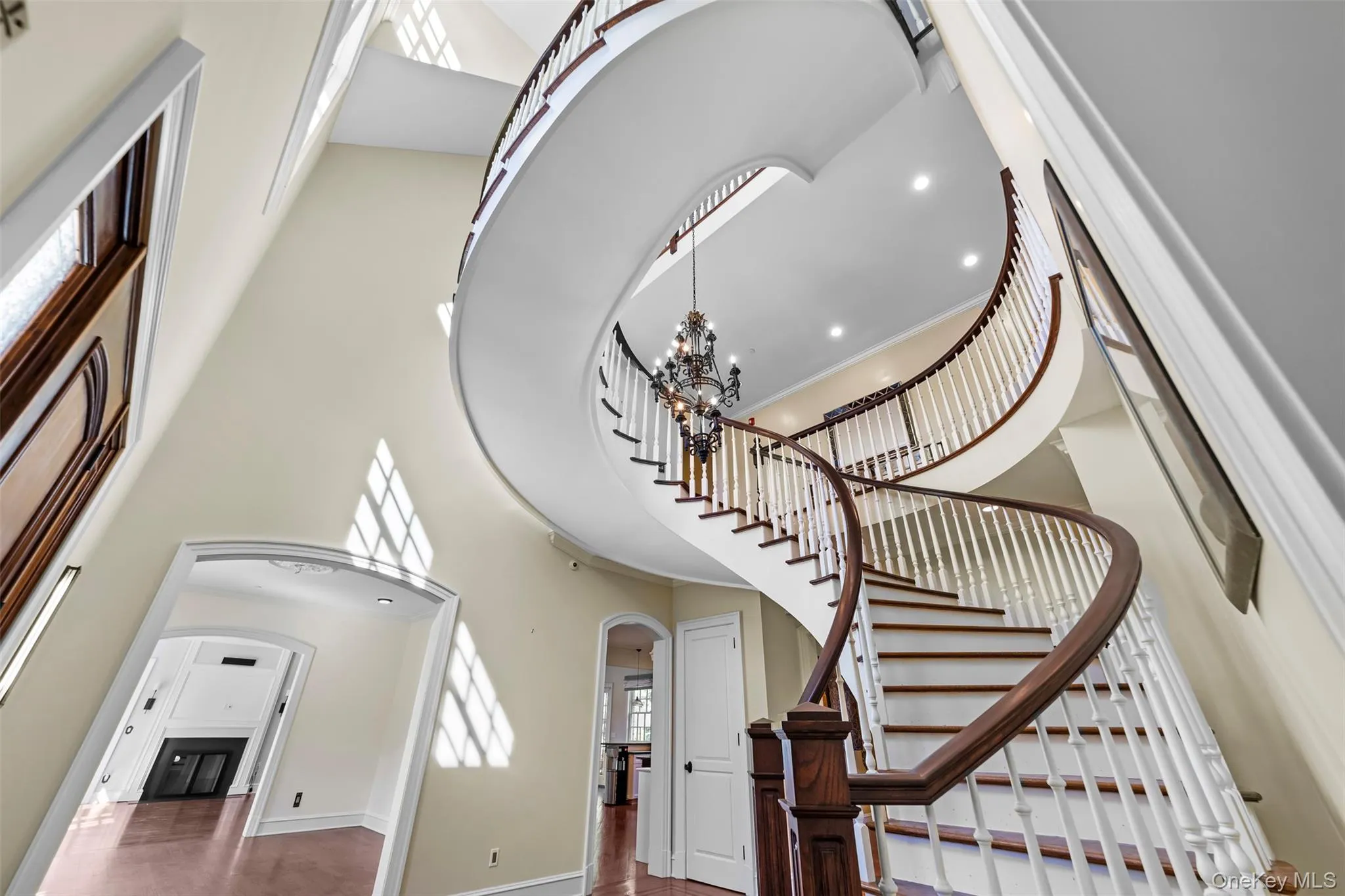 Dramatic three-story suspended spiral staircase anchors the home in architectural splendor Dramatic three-story suspended spiral staircase anchors the home in architectural splendor