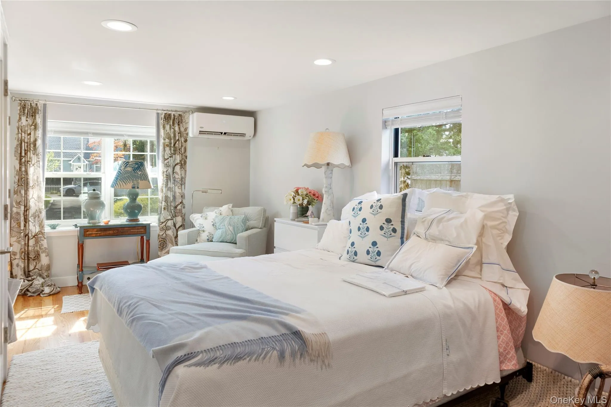 Bedroom with recessed lighting, wood finished floors, and a wall unit AC Bedroom with recessed lighting, wood finished floors, and a wall unit AC