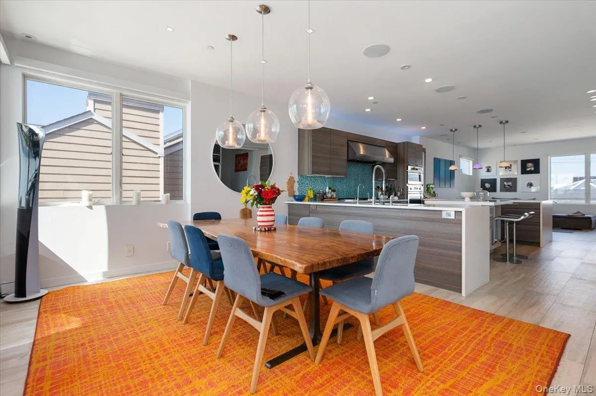 Dining space with light wood-style flooring and recessed lighting Dining space with light wood-style flooring and recessed lighting