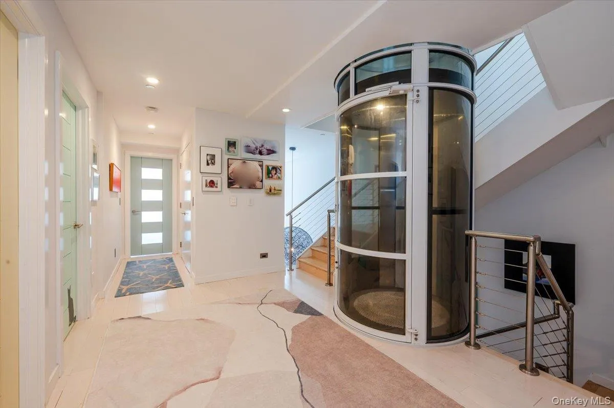 Entrance foyer featuring elevator, stairway, and recessed lighting Entrance foyer featuring elevator, stairway, and recessed lighting