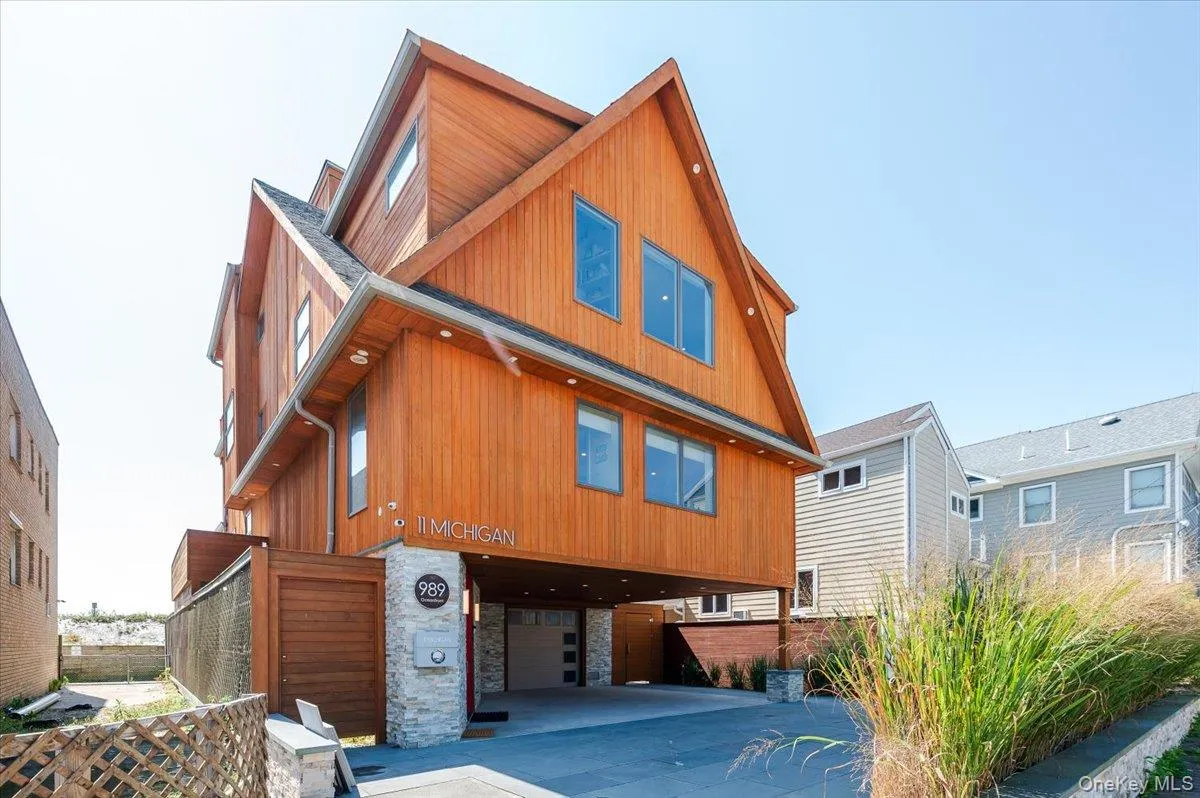 View of front of house featuring stone siding, a carport, and an attached garage View of front of house featuring stone siding, a carport, and an attached garage