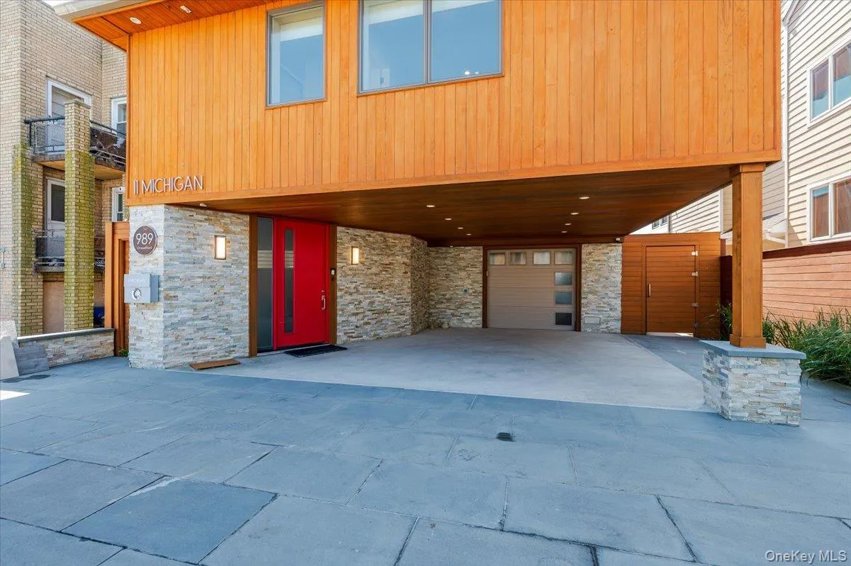 View of front of property with a carport, stone siding, and driveway View of front of property with a carport, stone siding, and driveway