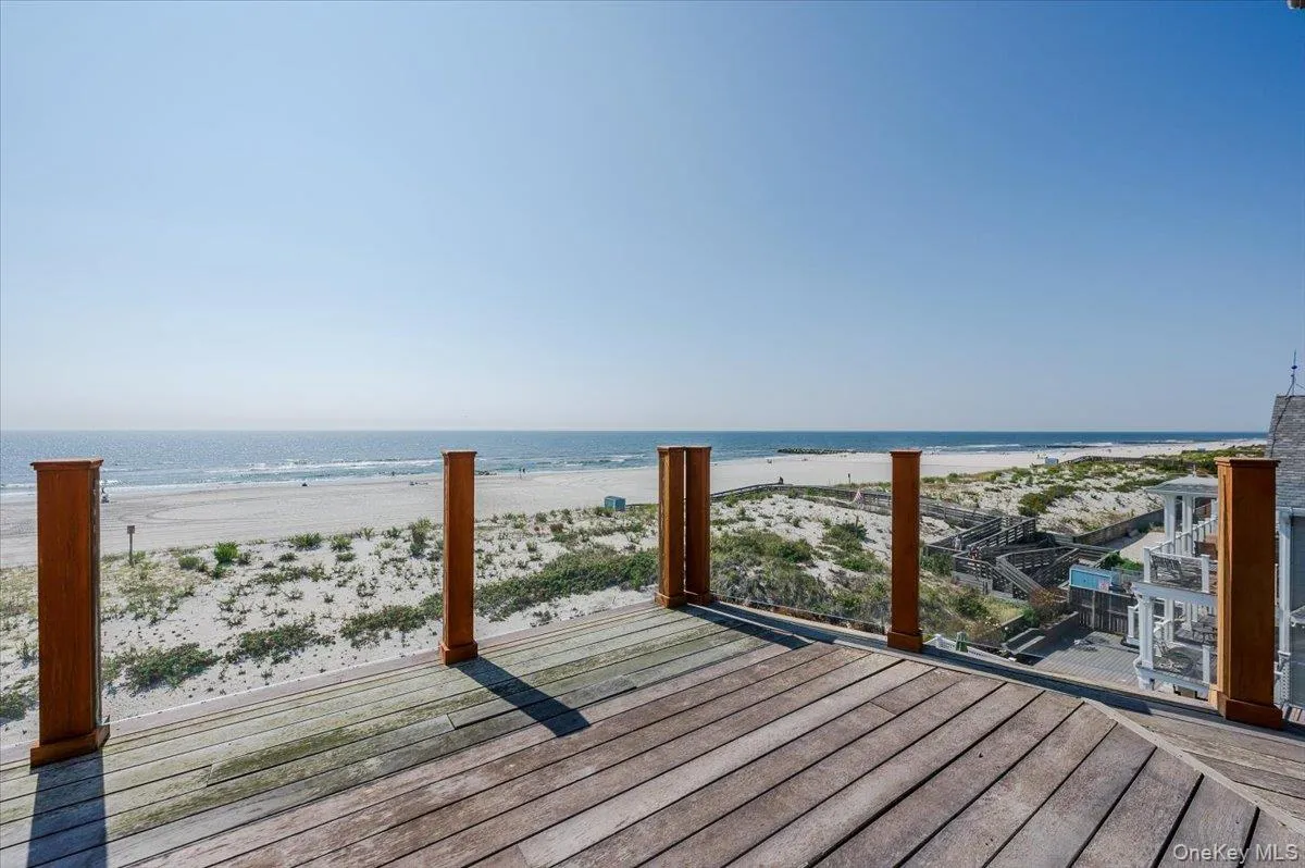 Wooden deck with view of water and beach Wooden deck with view of water and beach