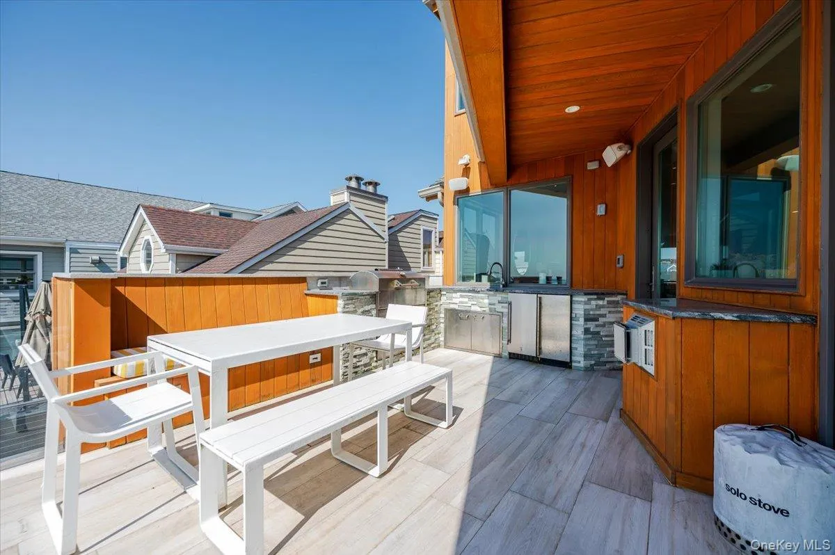 View of patio with outdoor dining area and an outdoor kitchen View of patio with outdoor dining area and an outdoor kitchen