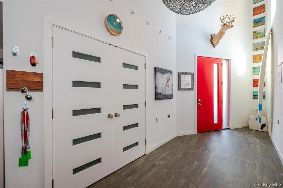 Foyer featuring baseboards and a high ceiling Foyer featuring baseboards and a high ceiling