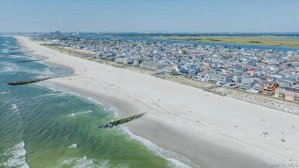 Aerial perspective of suburban area featuring expansive beach Aerial perspective of suburban area featuring expansive beach