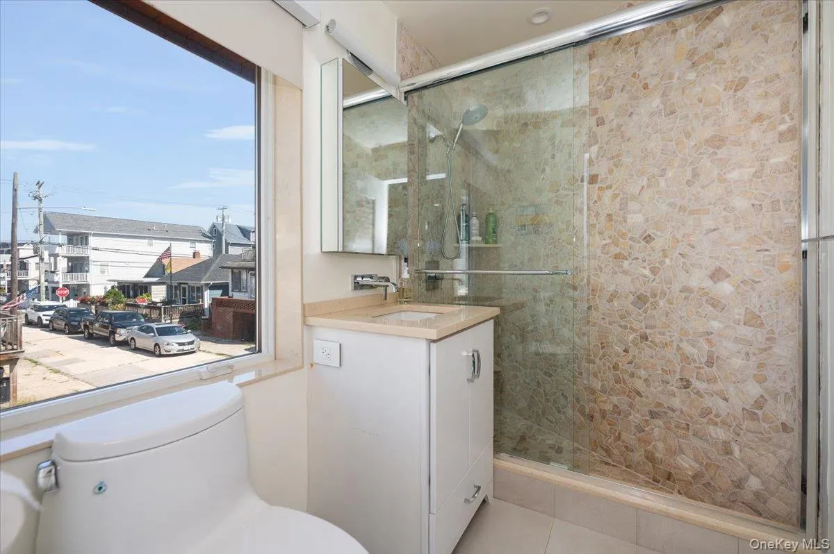 Full bathroom featuring vanity and a shower stall Full bathroom featuring vanity and a shower stall