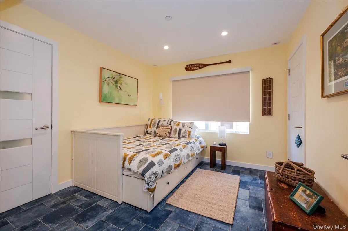 Bedroom featuring recessed lighting and dark stone finish flooring Bedroom featuring recessed lighting and dark stone finish flooring