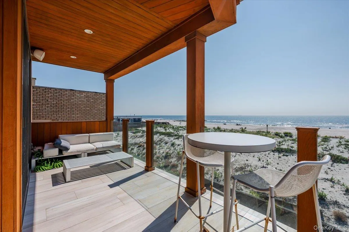Balcony featuring view of water and beach Balcony featuring view of water and beach