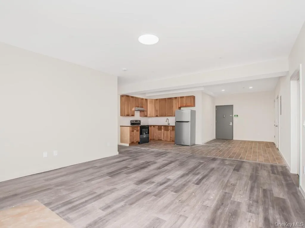 Unfurnished living room featuring light wood-style flooring and recessed lighting Unfurnished living room featuring light wood-style flooring and recessed lighting