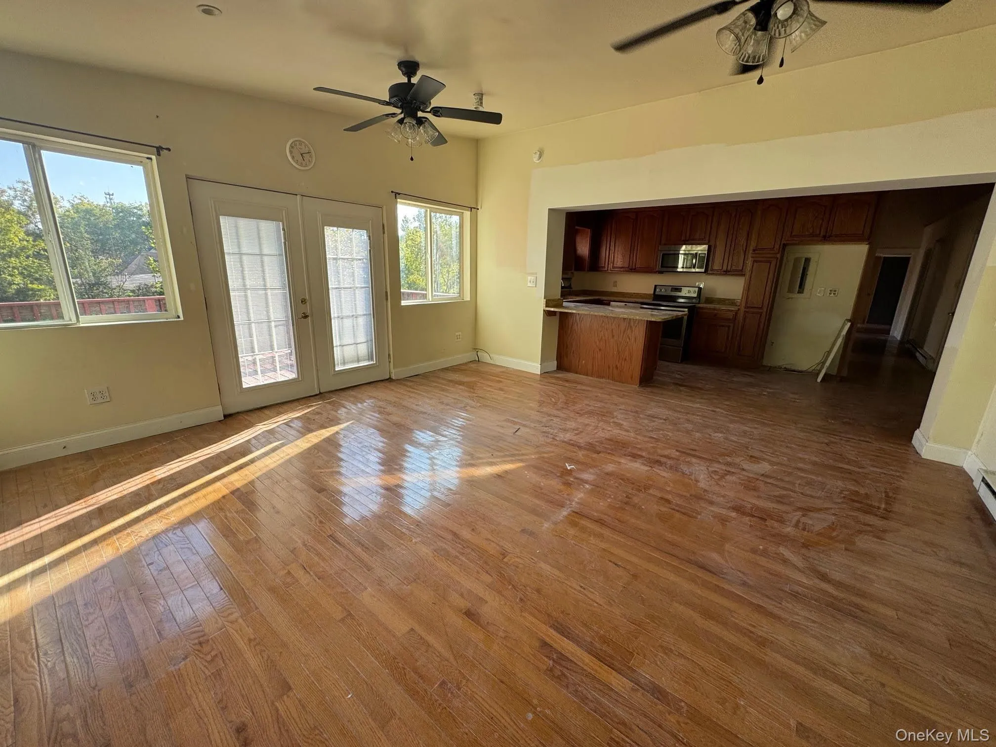 Kitchen and family room with door opening to a deck overlooking the yard. Kitchen and family room with door opening to a deck overlooking the yard.