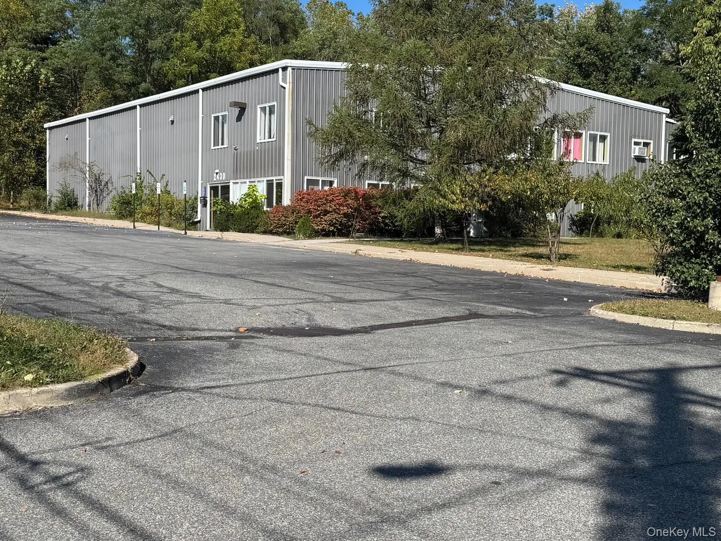 View of front/side of the building and some of the paved parking area. View of front/side of the building and some of the paved parking area.