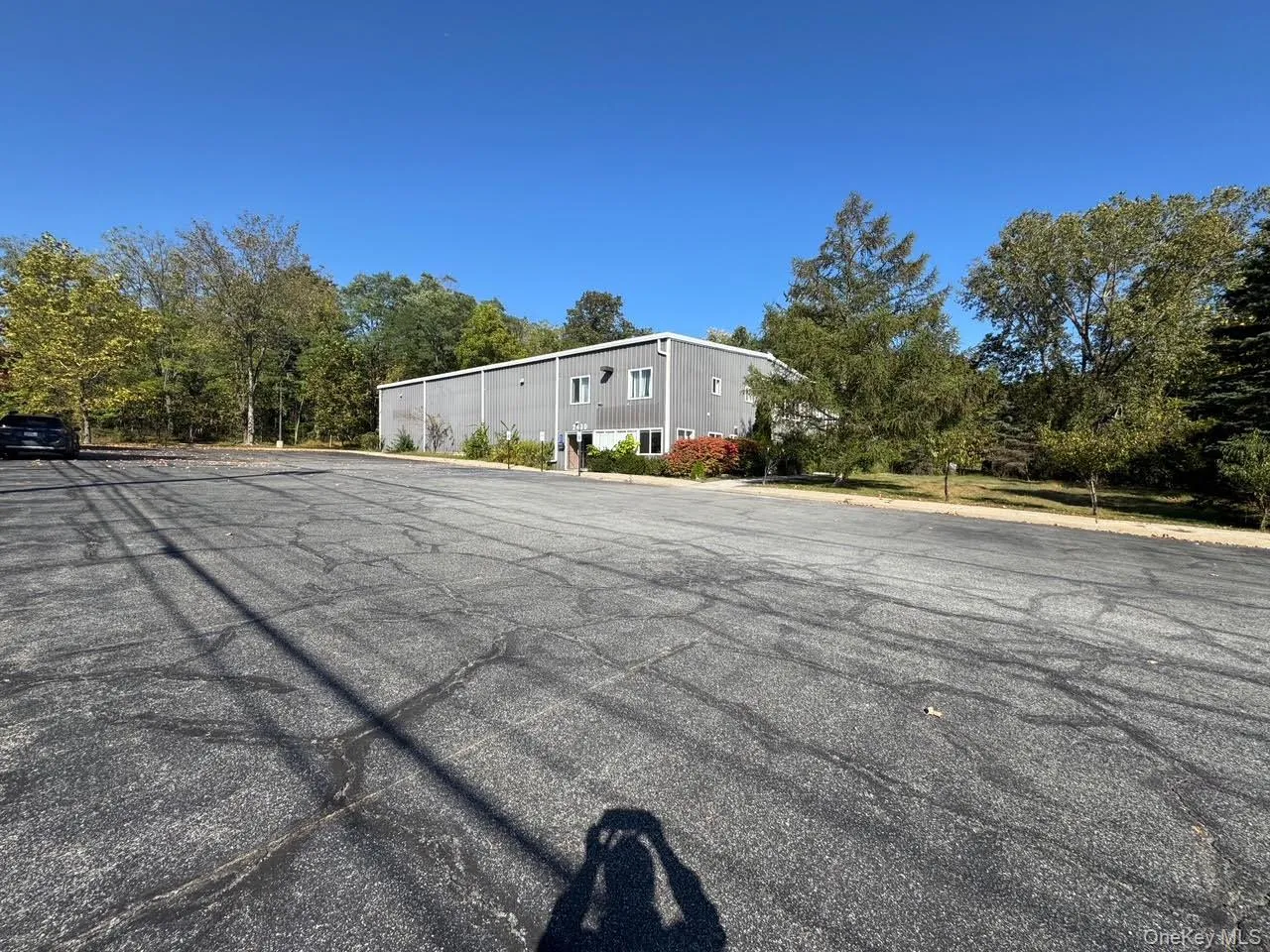 Front of the building with view of the paved parking lot. Front of the building with view of the paved parking lot.
